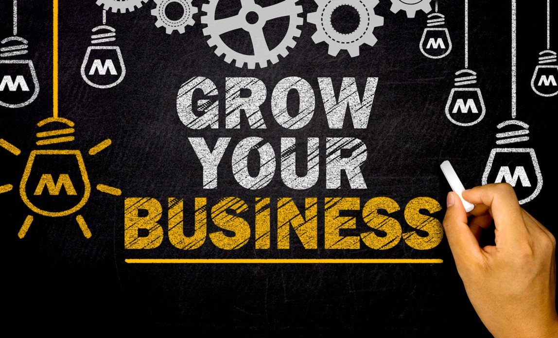 Digital marketing agency concept showing "Grow Your Business" text with light bulbs and gears representing business growth and innovation.